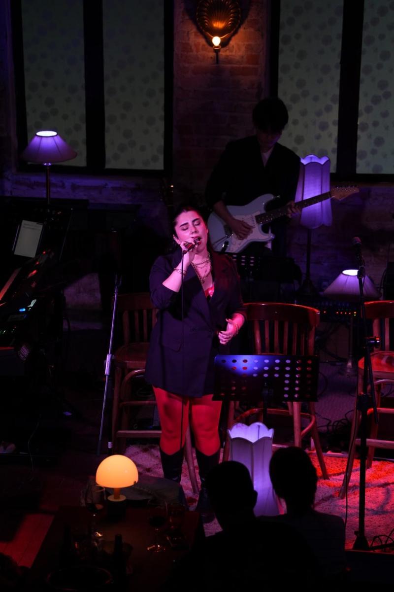 Pardis on a purple-lit stage