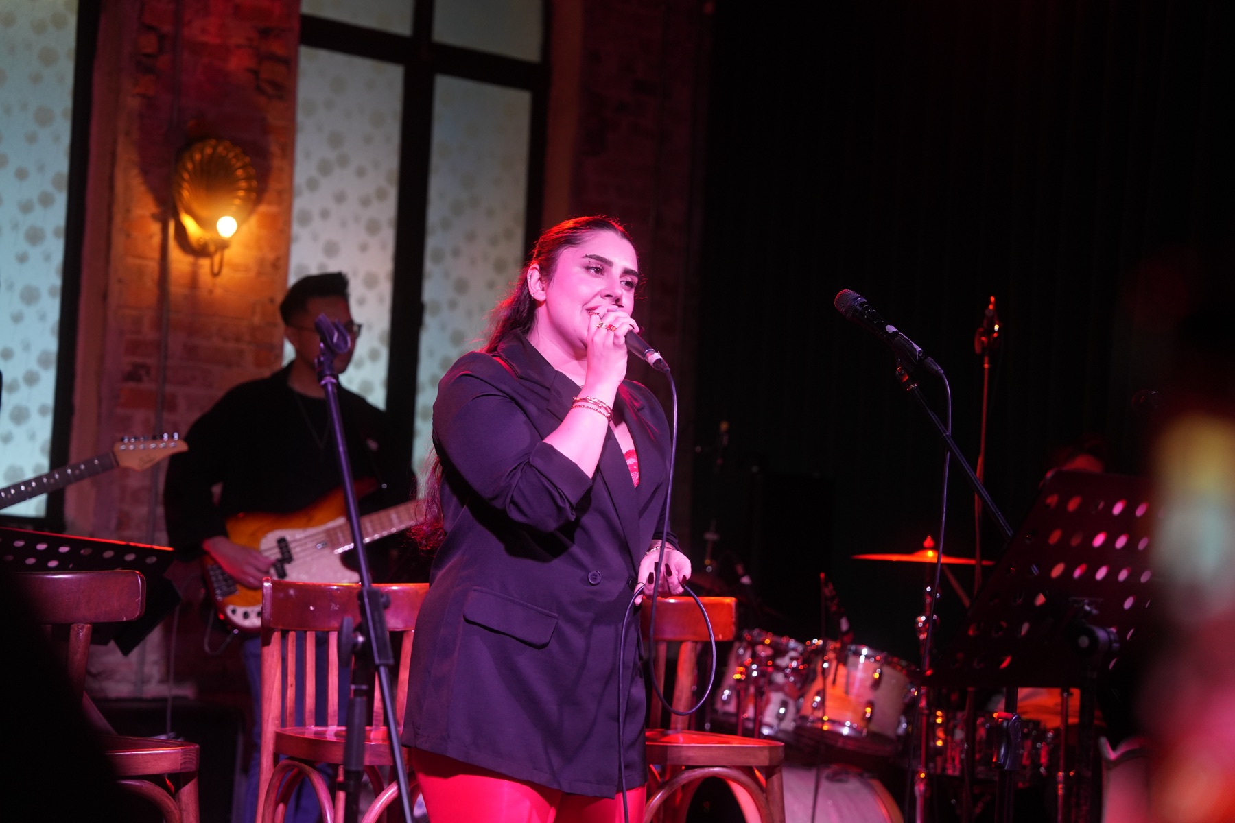 Pardis performing under stage lights
